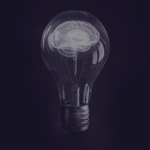 Human brain glowing inside of light bulb on dark background