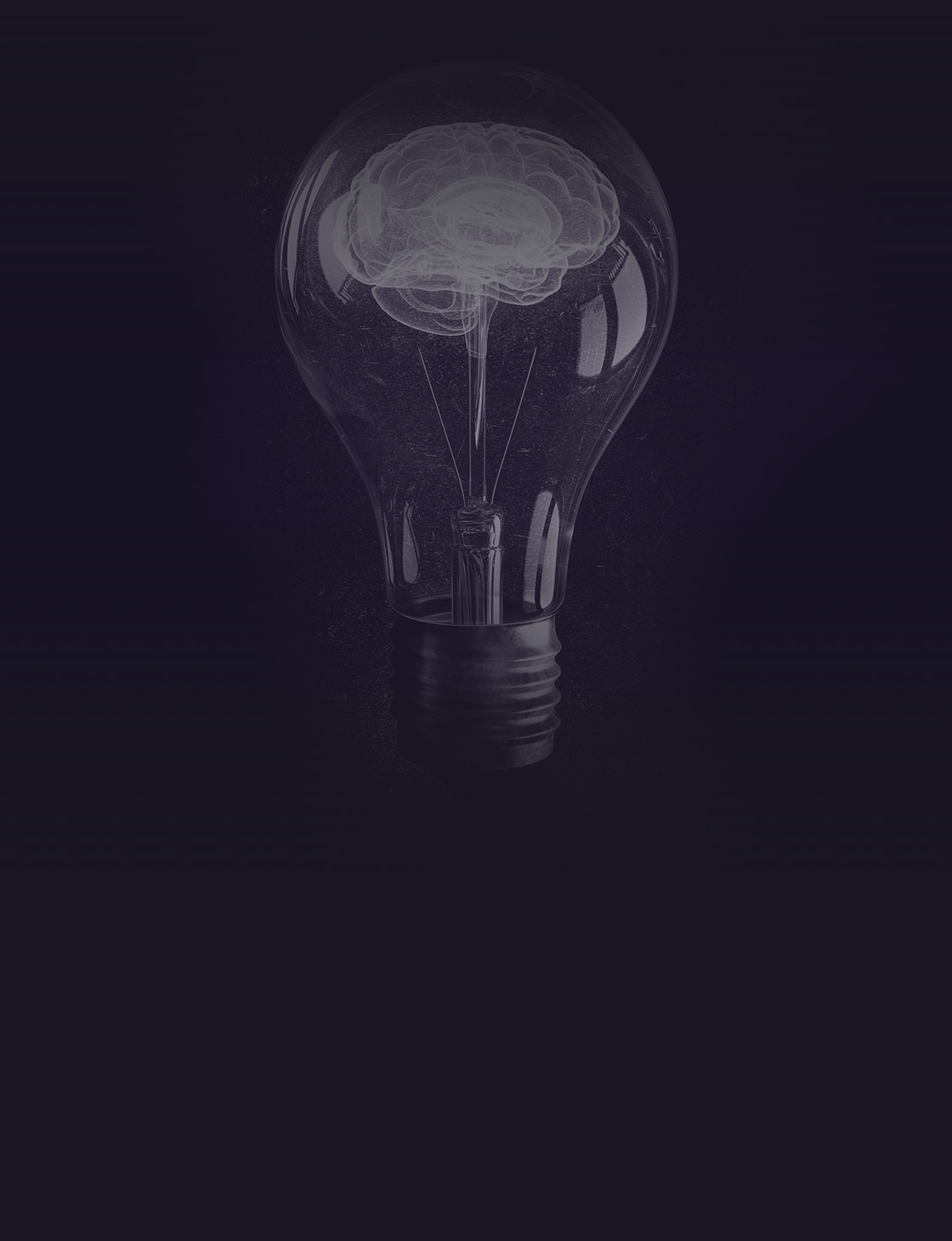 Human brain glowing inside of light bulb on dark background