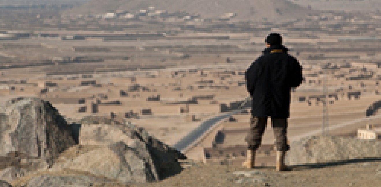 Afghan Security Guard Overlooking a Town
