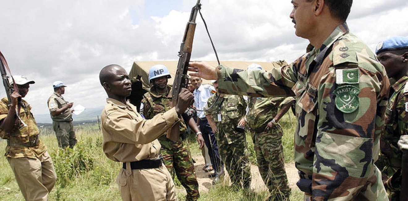 CNDD-FDD forces voluntarily disarm to UN peacekeepers at the end of the Burundian civil war in 2005. President Nkurunziza rose to power as chairman of the CNDD-FDD. Photo by United Nations Photo, Creative Commons