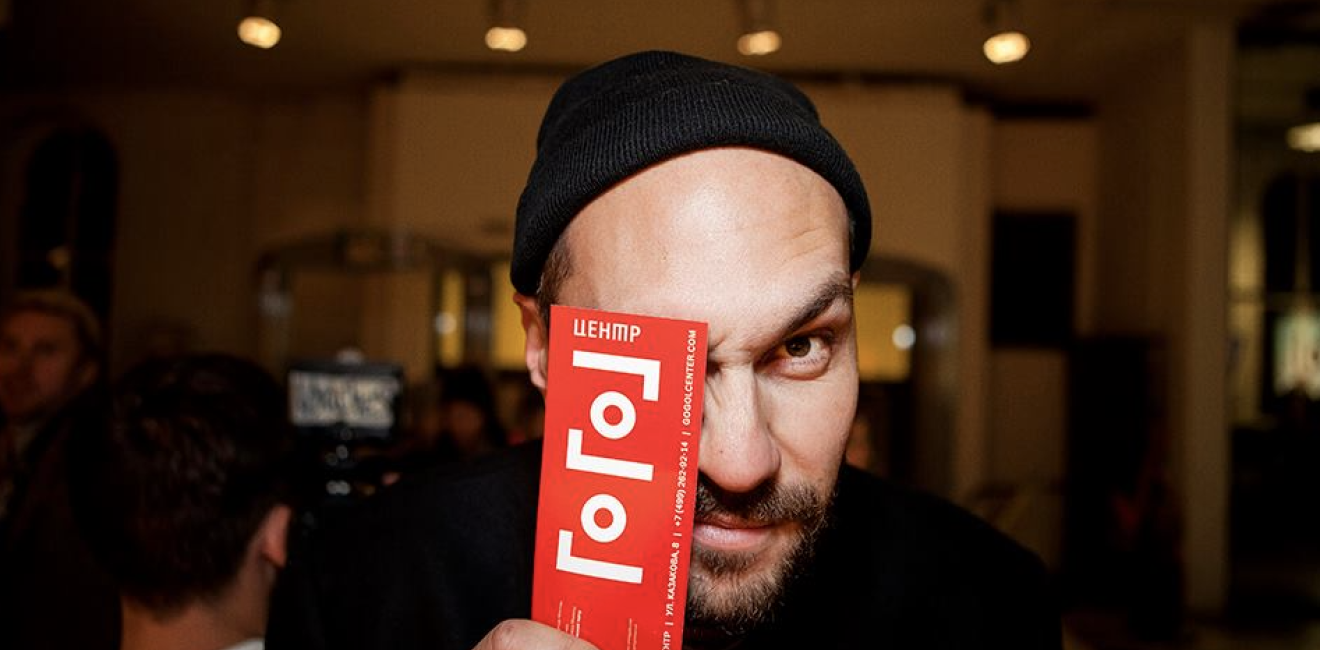 Man holding ticket over his eye