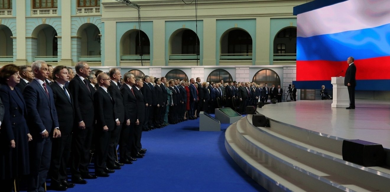 Putin on stage addressing the Federal Assembly of Russia
