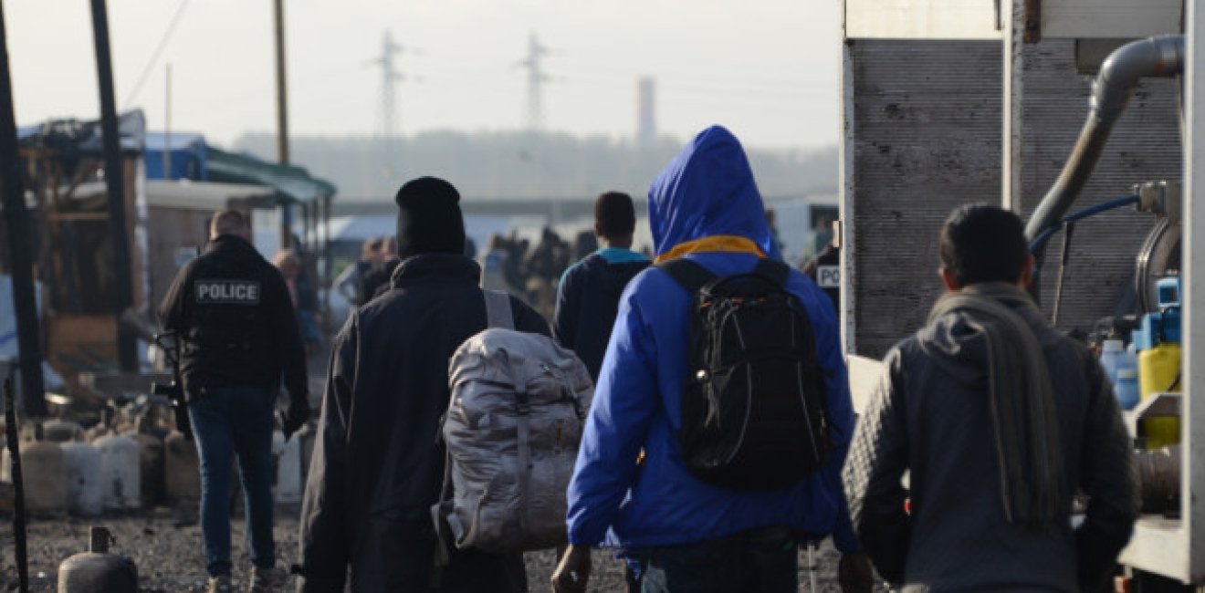  A group of migrants leave the Calais Jungle in Frane.