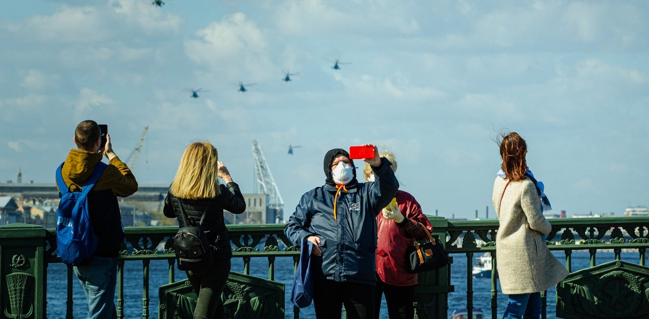 People in surgery masks outside during quarantine in Saint Petersburg, in celebration of Victory Day.