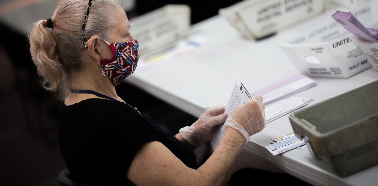 Election poll workers wear masks during the 2020 primary election day in Nevada.