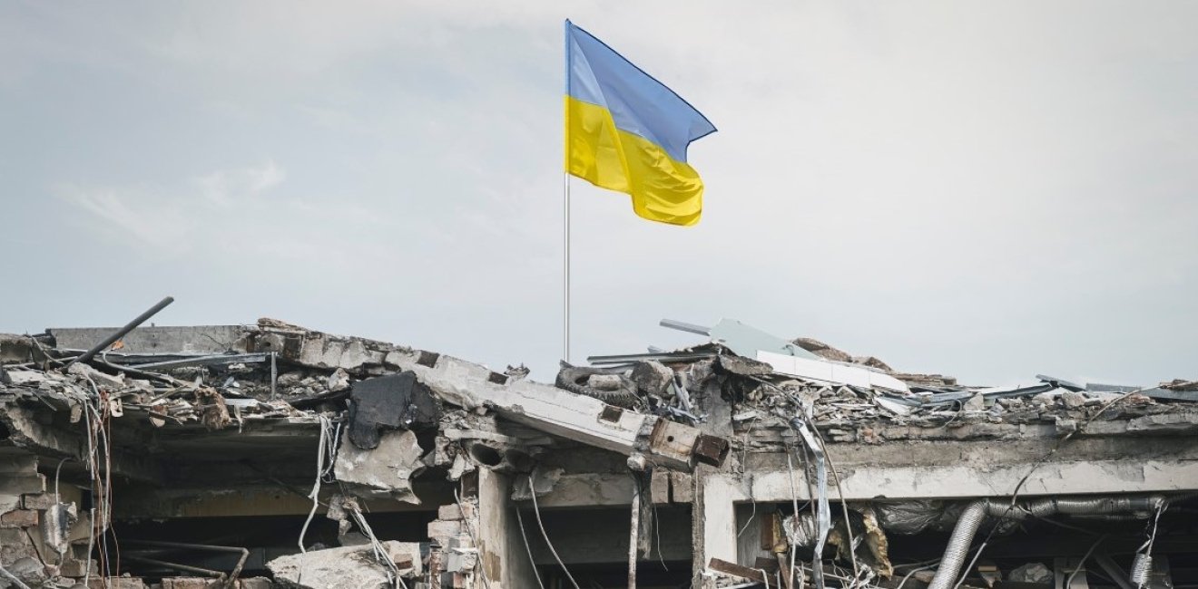 Ukraine flag over wreckage