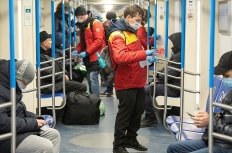 Health workers on a Moscow subway car.