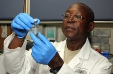 Biochemist looking at vial
