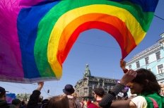 Saint-Petersburg, Russia - May 01, 2019: May demonstration. Marchers with a rainbow LGBT flag on Nevsky prospect.