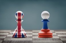 UK and Russia conflict. Country flags on chess pawns on a chess board. 3D illustration.