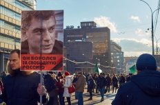 Moscow - February 27, 2016. Memory march of slain politician Boris Nemtsov. Demonstrator with a banner "He fought for free Russia" and portrait of Boris Nemtsov