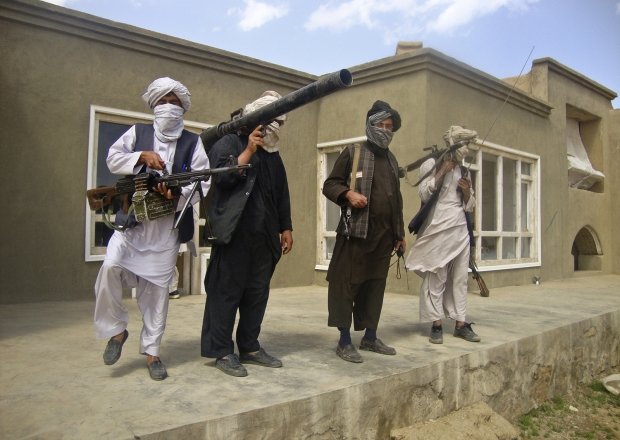 Taliban fighters pose with weapons at an undisclosed location in southern Afghanistan in this May 5, 2011 picture. REUTERS/Stringer