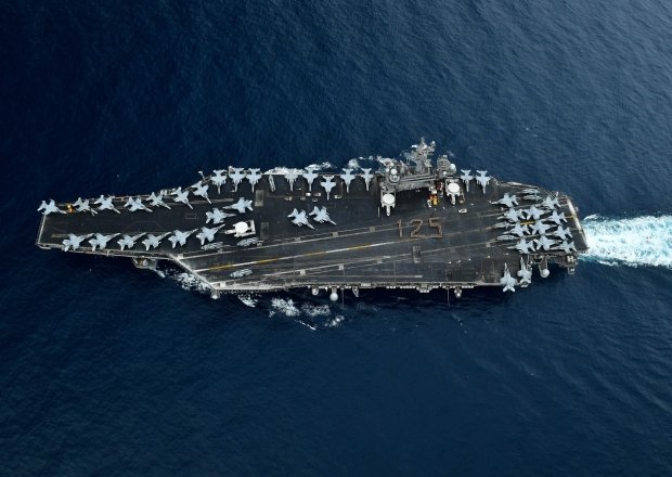 A U.S. aircraft carrier travels through the Malacca Straits.