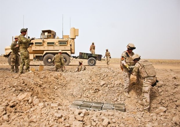 U.S. Air Force and Slovakian explosive ordnance disposal personnel unload a trailer in Afghanistan