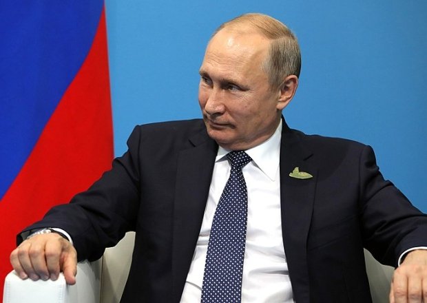 Vladimir Putin in sitting in chair