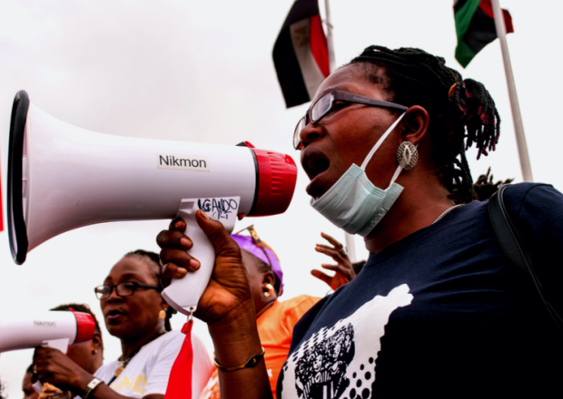 Women trying to make there voices heard using a megaphone