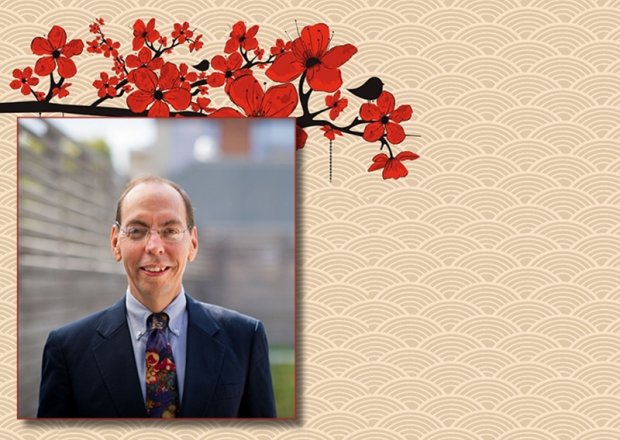 A photo of Jacques deLisle on a background with cherry blossoms.