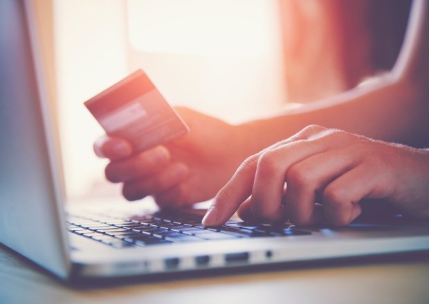 Person making a credit card purchase with computer