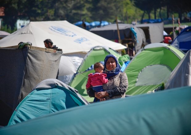 Woman with a baby in transit refugee/migrant camp at the Greek-North Macedonian border.