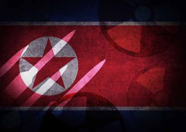 A photo of the North Korean flag with an image of missiles superimposed on top.