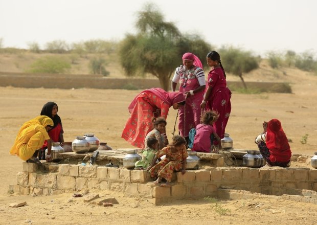 Women drawing water from a well