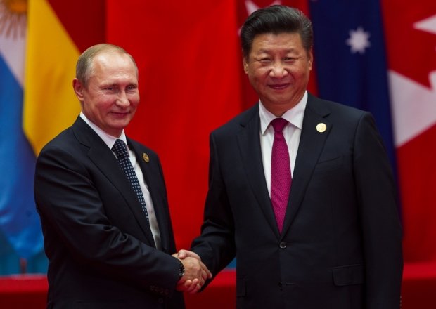 HANGZHOU, CHINA - SEPT. 4. 2016 - Chinese president Xi Jinping (R) welcomes Russian President Vladimir Putin (L) in G20 summit in Hangzhou.