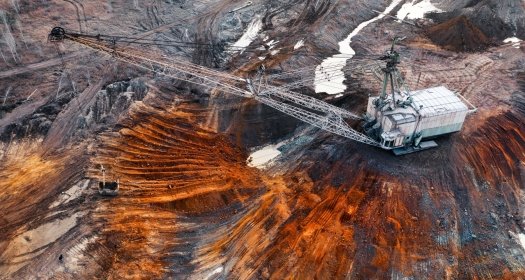 An excavator in a quarry extracting rare minerals.