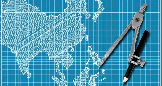 A blueprint style map of Asia with a drawing compass on top.