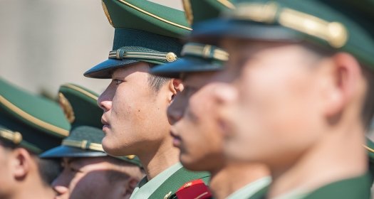 A close up of a line of Chinese soldiers.