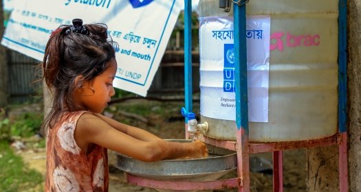 Child in a Cox’s Bazar refugee camp washes their hands in a newly installed wash station as a precaution for Covid-19