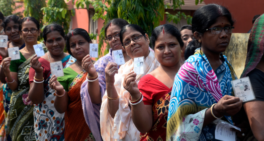 Indian women stand in queue with their Voter ID Card in hand during the West Bengal Three tier Panchayat Election approximate 40 k.m. from state capital Kolkata on May 14, 2018 in Hooghly, India.