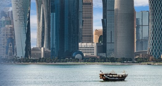 Boat in the water in front of large modern highrises
