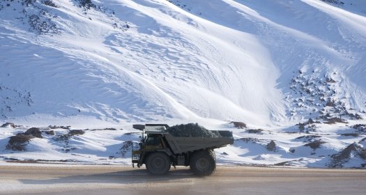Photo of a truck hauling ore in the snow