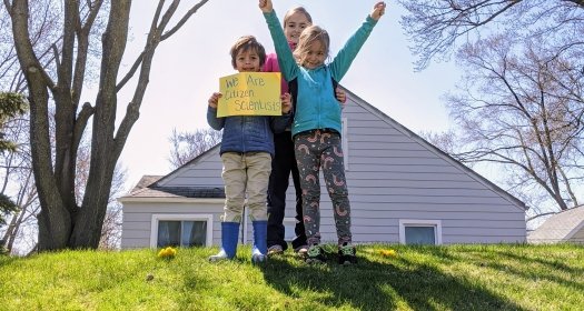 Children holding a sign of we are citizen scientists