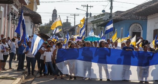 Granada, Nicaragua - May 29, 2018: peaceful protests in Granada Nicaragua for reform of INSS, people flying the Nicaraguan flag