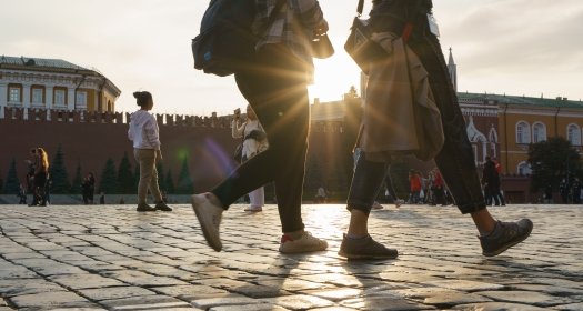 Two women walk across Red Square in Moscow