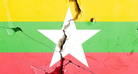The Myanmar national flag painted on a cracked background
