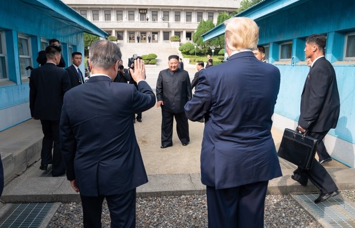 Kim Jong Un waves to President Trump and President Moon at the DMZ.