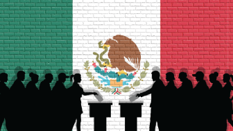 Silhouettes of voters in front of a Mexican flag