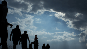 Refugees walking on horizon