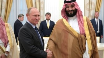 Vladimir Putin shaking hands with Crown Prince of Saudi Arabia Mohammad bin Salman.