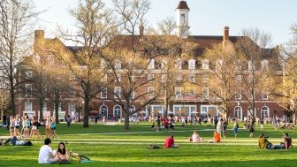 Students mingle on Quad lawn of University of Illinois college campus in Urbana Champaign