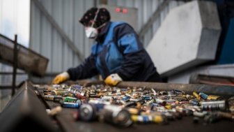  A female worker works on used batteries that are sent to recycling plant.