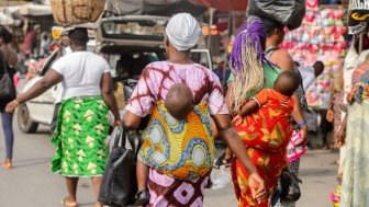 Little babies carried by their mothers at a market in West Africa.
