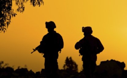 Soldiers in front of a sunset