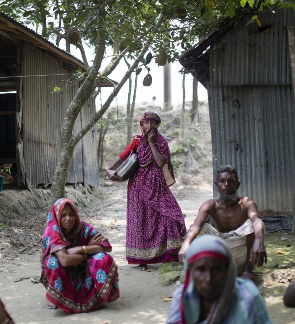 Bangladesh villagers sitting on ground