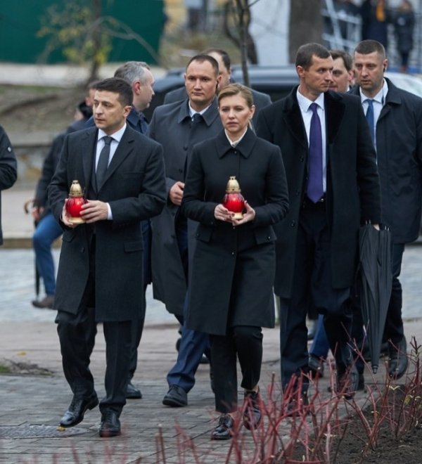 Ukrainian President Volodymyr Zelenskyy and his wife, Olena Zalenska, hold candles as they walk to a memorial in Independence Square in Kyiv, Ukraine. Source: President.gov.ua