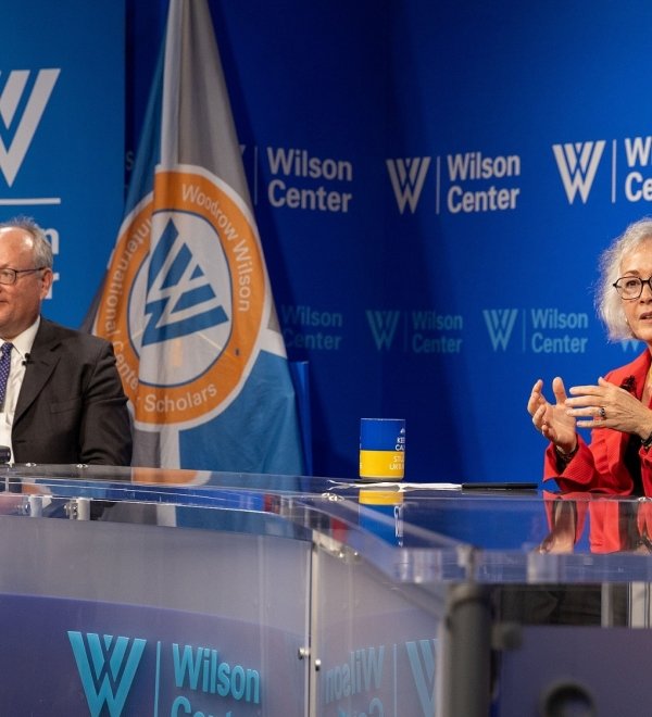 Marie Yovanovitch sits in front of Wilson Center branding