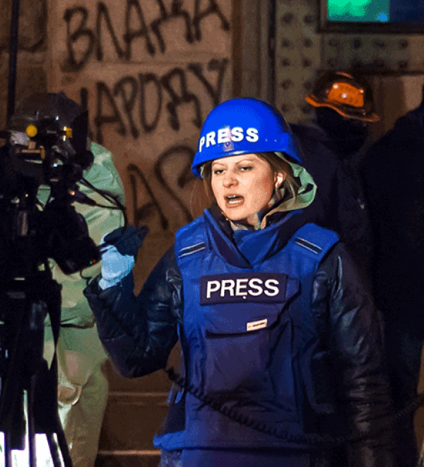 Press in blue body armor in Kyiv during protests.