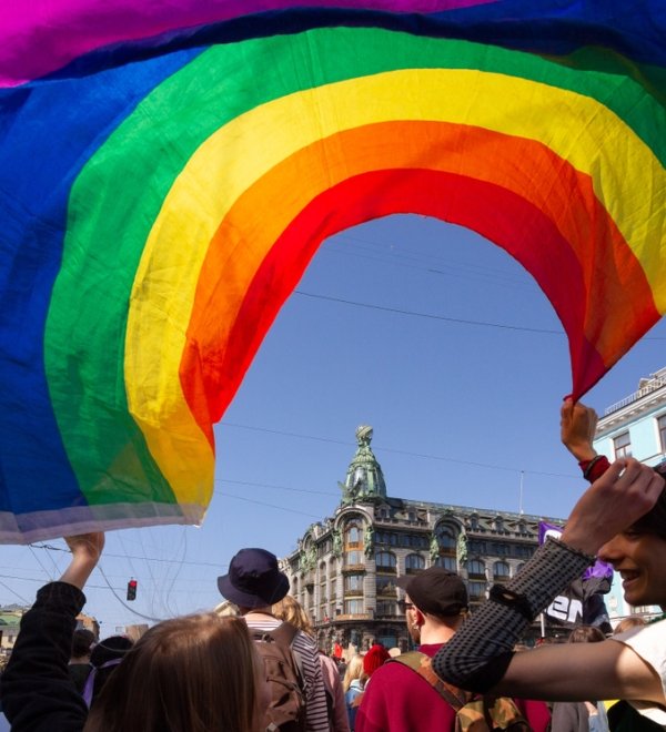 Saint-Petersburg, Russia - May 01, 2019: May demonstration. Marchers with a rainbow LGBT flag on Nevsky prospect.